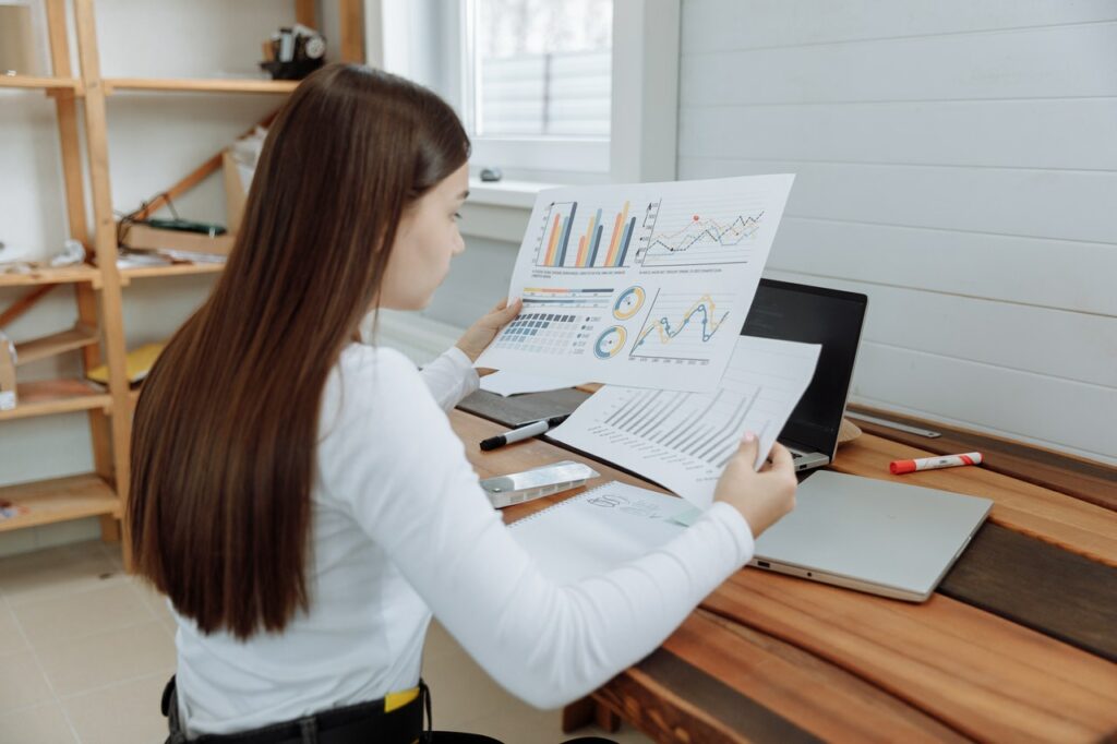 woman looking at project documents at a desk